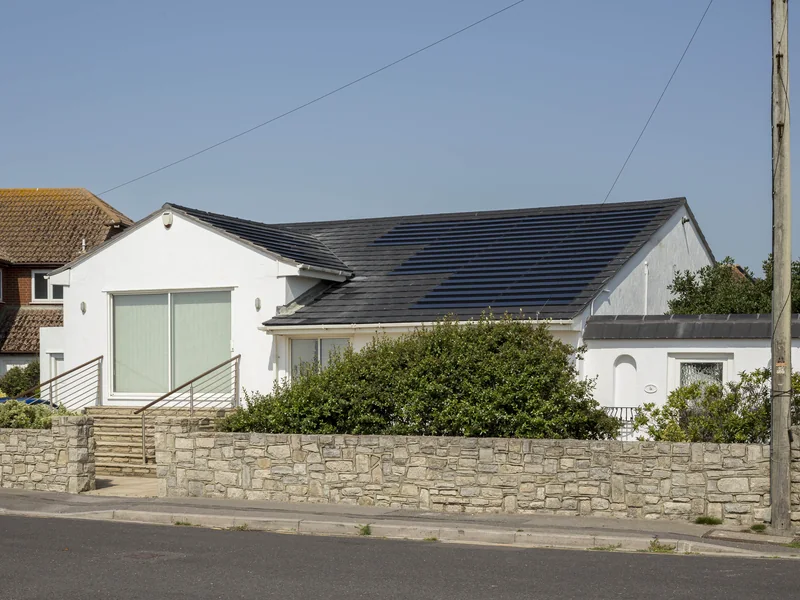 Completed black SolarTyle roof photographed from an oblique street angle