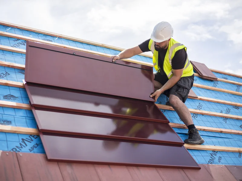 SolarTyle installer fitting a red integrated solar module at Moor Hall Road