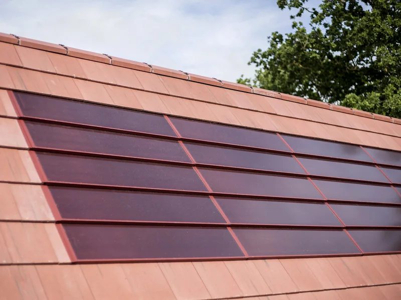 Completed red SolarTyle modules integrated with matching roof tiles
