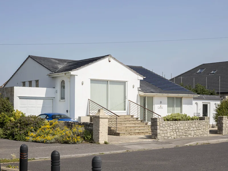 Completed black SolarTyle roof across several elevations at Solent Road