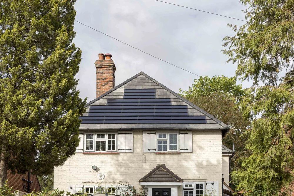 Ground-level view of the anthracite SolarTyle roof and chimney