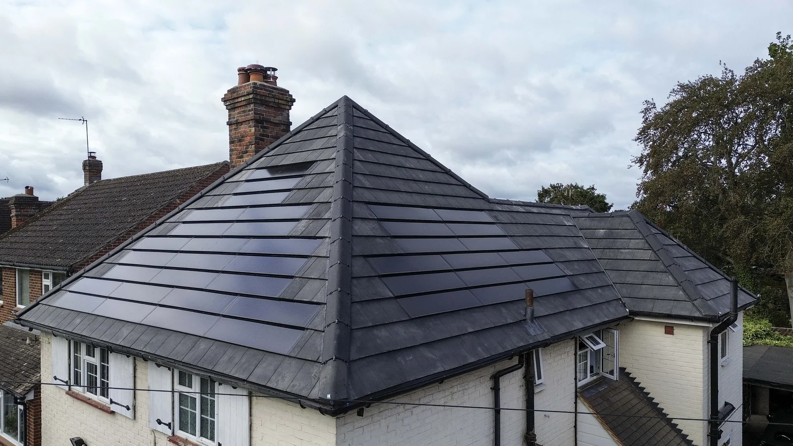 Hipped SolarTyle roof and chimney at Mead Cottage in Normandy, Guildford
