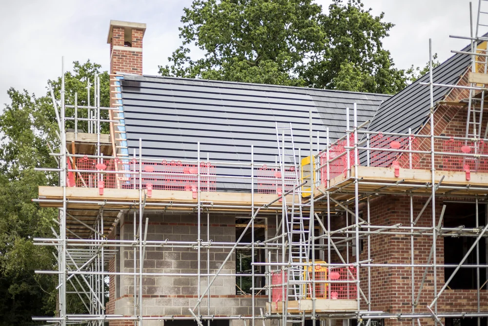 An anthracite SolarTyle roof on a Moor Hall home with scaffolding still in place