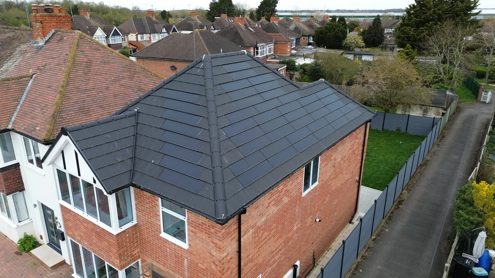 Closer view of the anthracite tile courses and roof hips