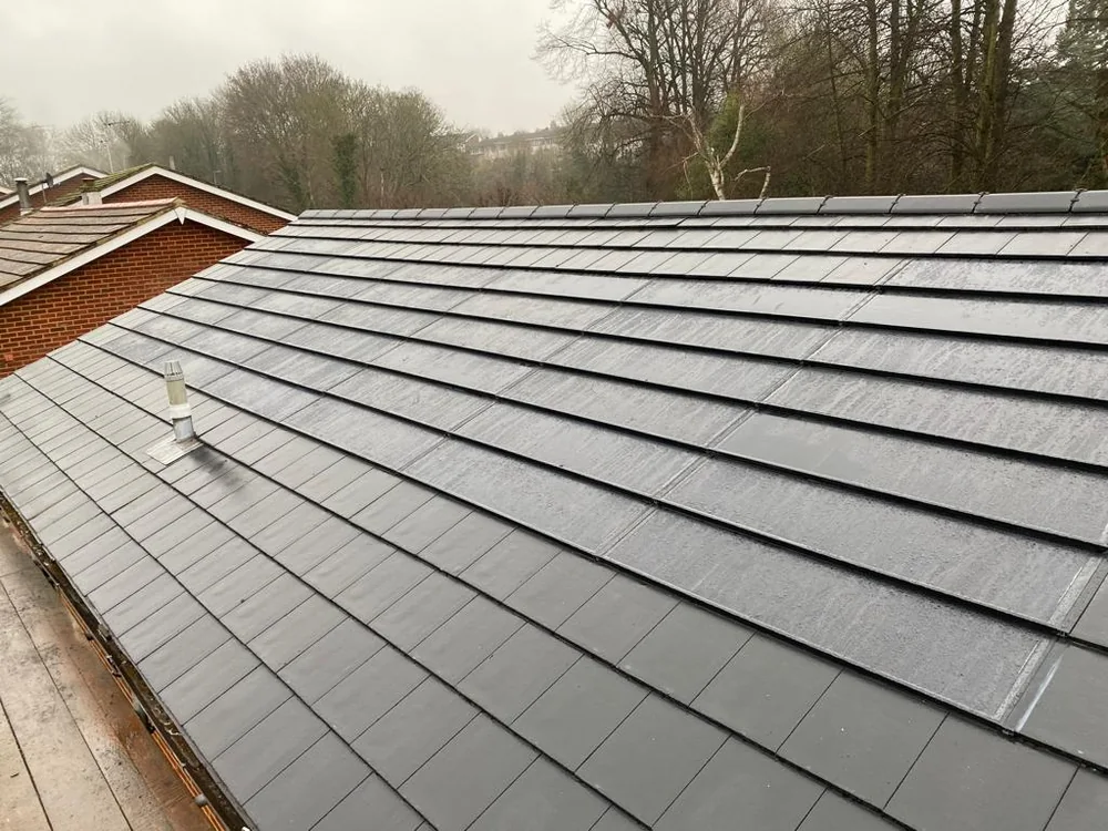 Close-up of solar tile courses and surrounding roof tiles at Orchard Close