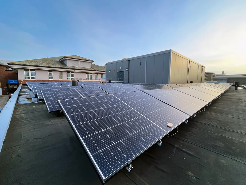 Conventional photovoltaic panels arranged on a flat hospital roof at Blackpool
