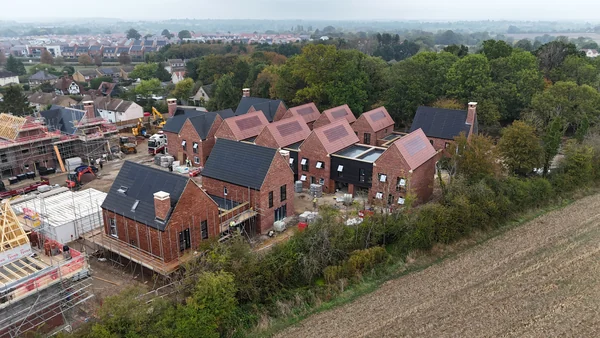 Red and anthracite SolarTyle roofs across Moor Hall, Harlow