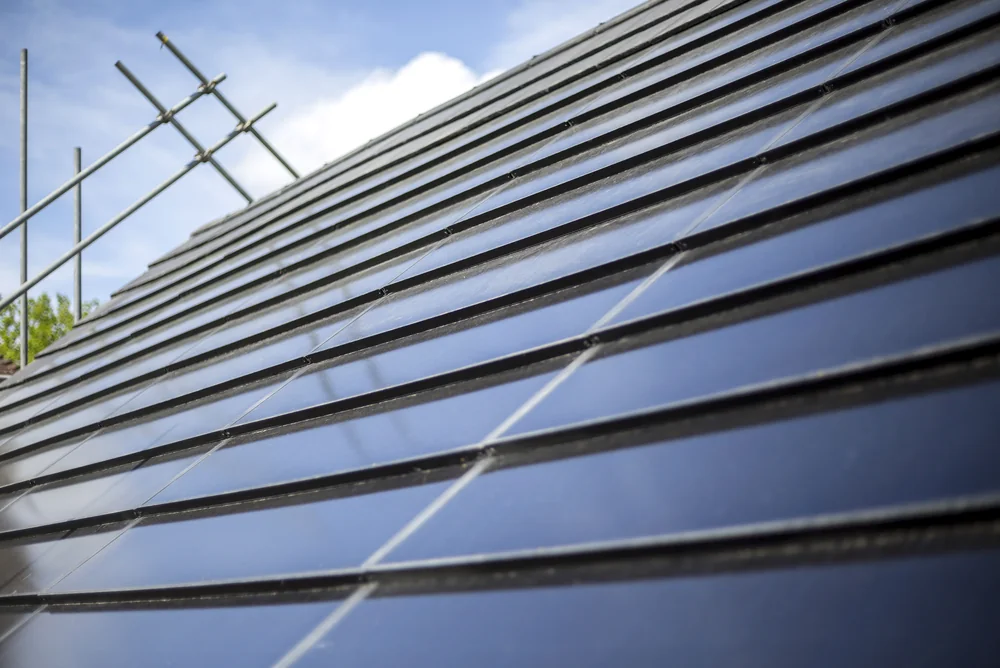 Real anthracite SolarTyle modules aligned within the surrounding roof covering